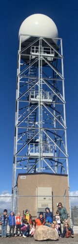 A group of PPOS students stand in front of the radar tower at the La Plata County Airport