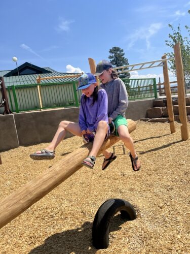 Westin and Avery try out the new teeter-totter on the Pagosa Peak Open School’s new playground.