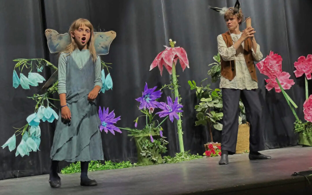 Two PPOS students on stage in costume for a scene from a Midsummers Night Dream.