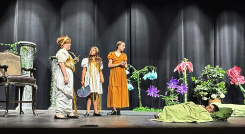 Four PPOS students on stage in costume for a scene from a Midsummers Night Dream.