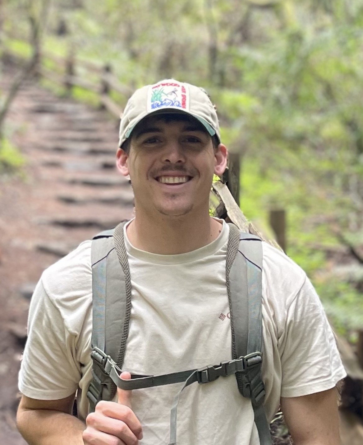 Jeremy Gardner hiking down some stairs with a backpack